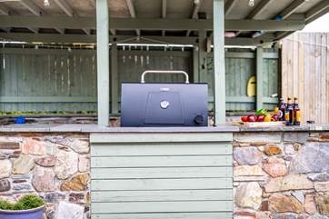 The covered kitchen area offers the perfect barbecue area!