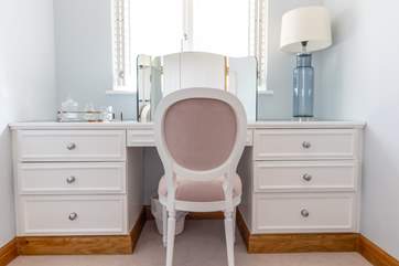The elegant dressing area with shutters custom made to fit the windows.