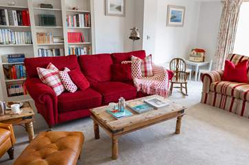 The formal sitting-room enjoys a log-burner and patio doors that lead out on to the garden.