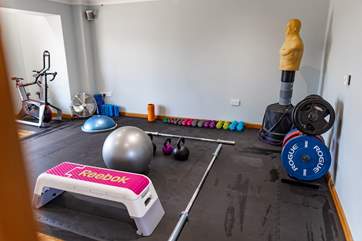 A studio gym including 2021 Watt bike atom, hand weights, Olympic barbell and plates up to 200kg, medicine ball, Bosu, stability balls, foam rollers, step, kettlebells, mobility bands, skipping ropes and yoga mats and blocks.
