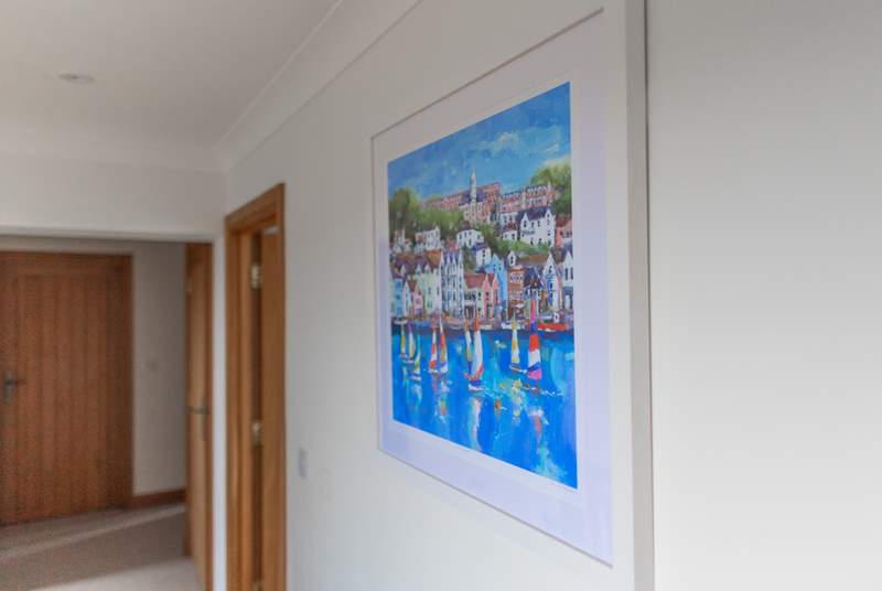 Local art of local coastal towns add a dash of colour throughout the house.