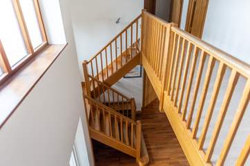 The landing is open and you can install the stair-gate at the top of the stairs as shown in the picture.