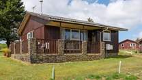 The lodge sits on a lodge site with other lodges around.