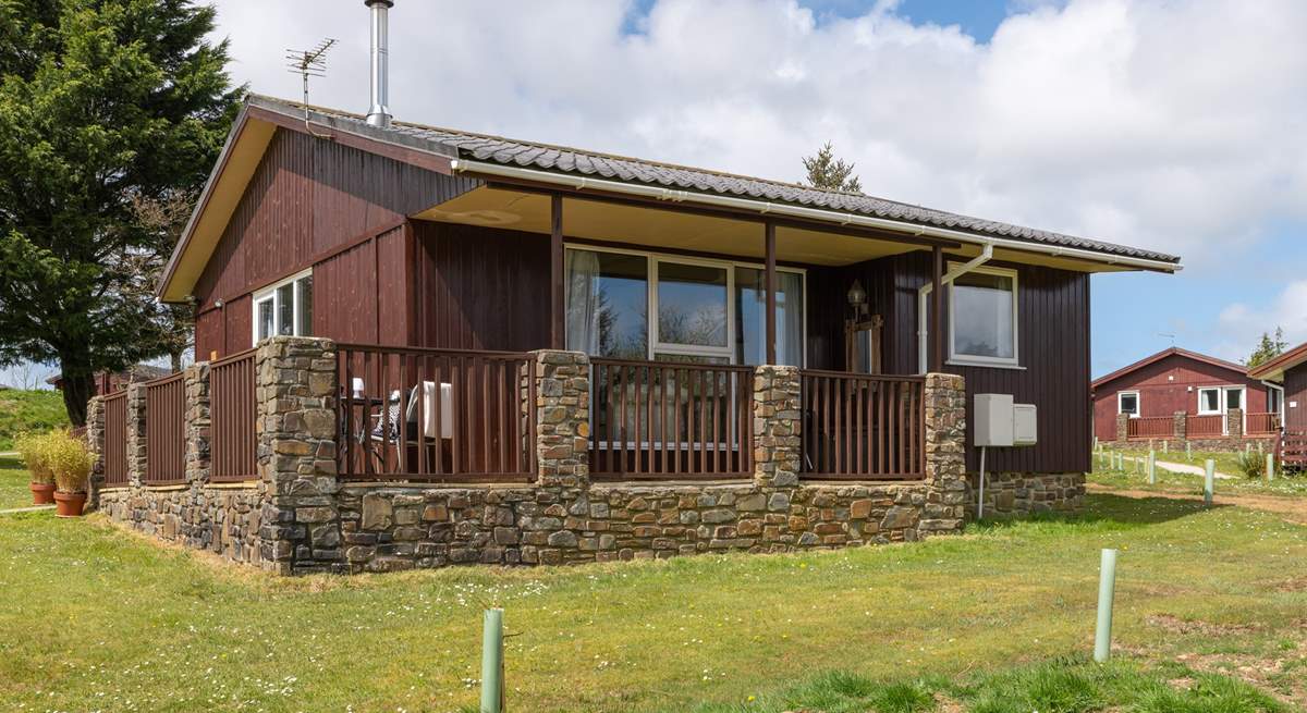 The lodge sits on a lodge site with other lodges around.