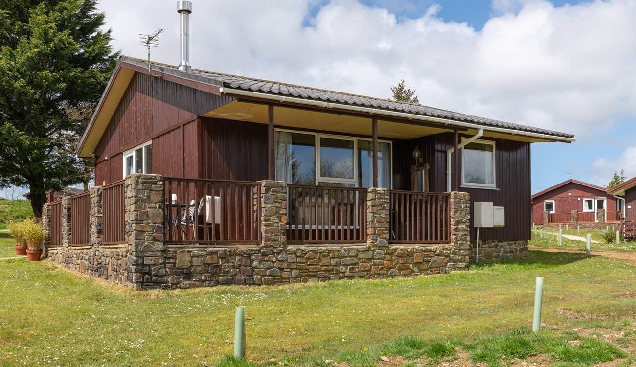 The lodge sits on a lodge site with other lodges around.