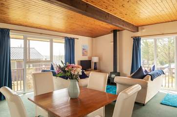 The open plan living-room floods with light and has a multi-burner.