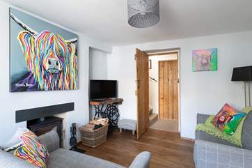 The sitting-room leads through to the stairs and downstairs shower-room.