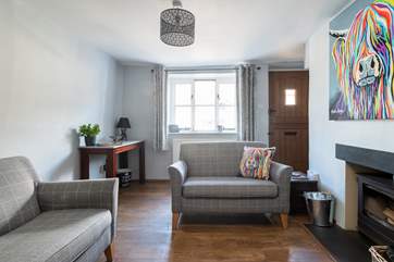 The cottage has lovely deep windows that offer glimpses of the village.