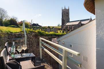 The seating area is raised and should be used with caution owing to uneven ground and steep steps. Once seated you have a perfect village view!