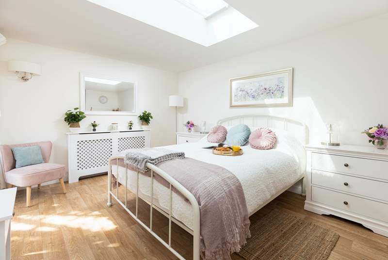 A bedroom that will not fail to impress, which sits two steps down from the hallway opposite the bathroom.