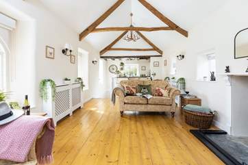 Open plan living that is very light thanks to the dual-aspect windows. to the left of the kitchen you will find the stairs down to the bedroom and bathroom on the lower ground floor. The entire lodge floods with light.