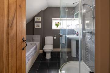 The family bathroom has a bath and luxurious shower unit.