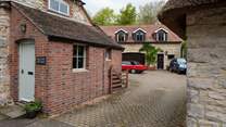 A view to show the shared driveway and courtyard area. There is a house behind Halcyon Cottage and one to the right. You will drive in to this area and turn immediately left where you can park your car at the back of the cottage.