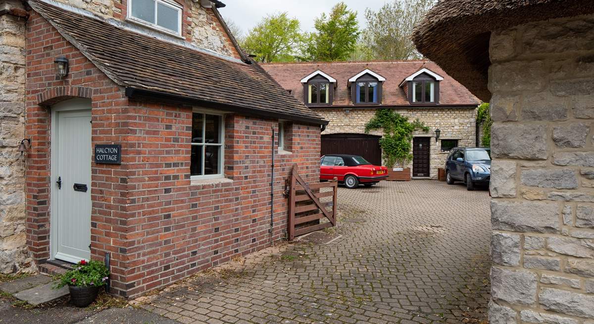 A view to show the shared driveway and courtyard area. There is a house behind Halcyon Cottage and one to the right. You will drive in to this area and turn immediately left where you can park your car at the back of the cottage.