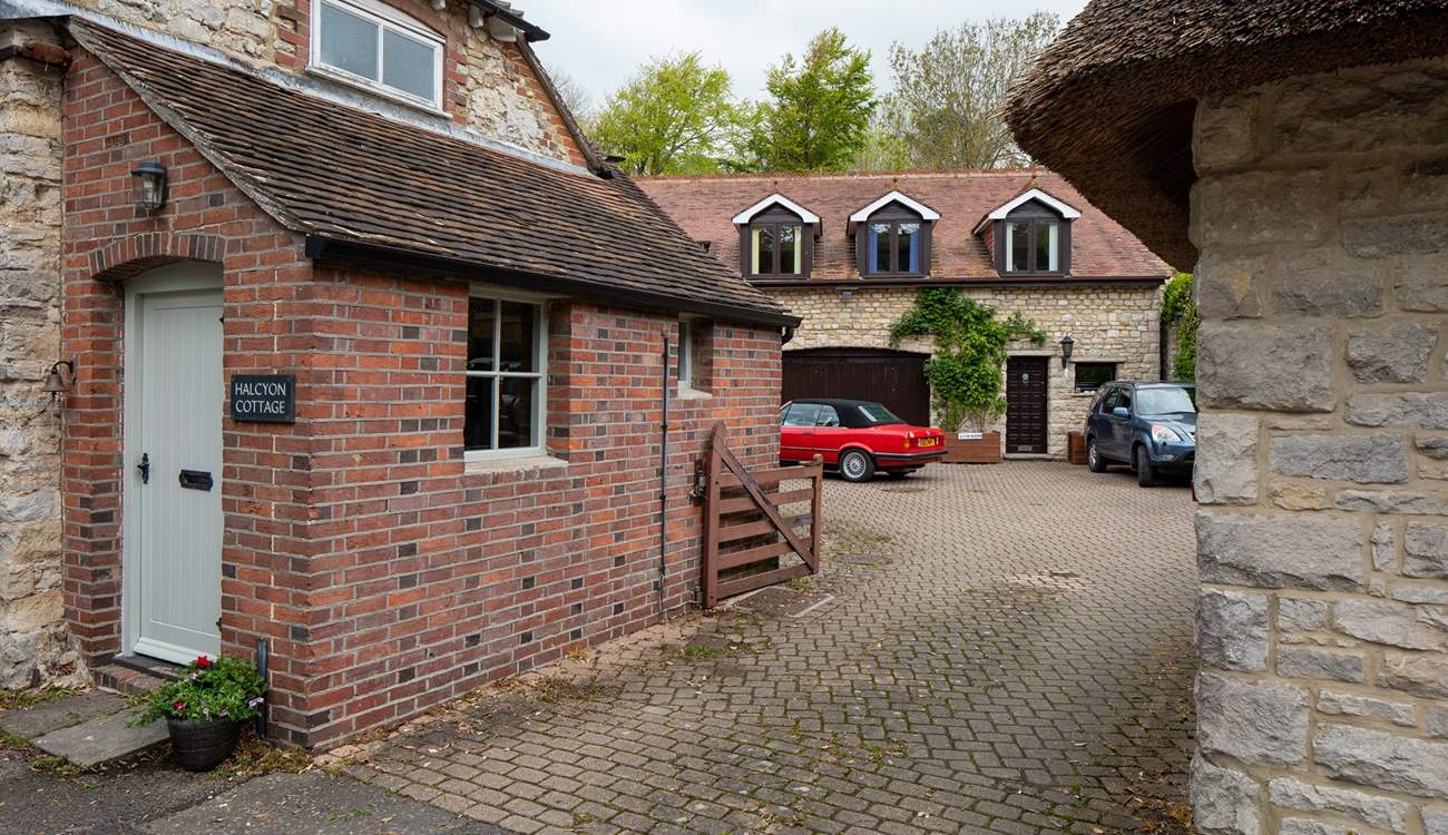 A view to show the shared driveway and courtyard area. There is a house behind Halcyon Cottage and one to the right. You will drive in to this area and turn immediately left where you can park your car at the back of the cottage.