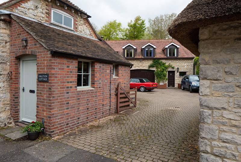 A view to show the shared driveway and courtyard area. There is a house behind Halcyon Cottage and one to the right. You will drive in to this area and turn immediately left where you can park your car at the back of the cottage.