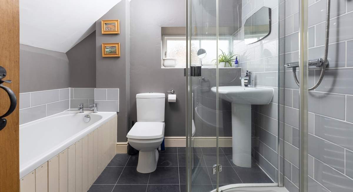 The family bathroom has a bath and luxurious shower unit.