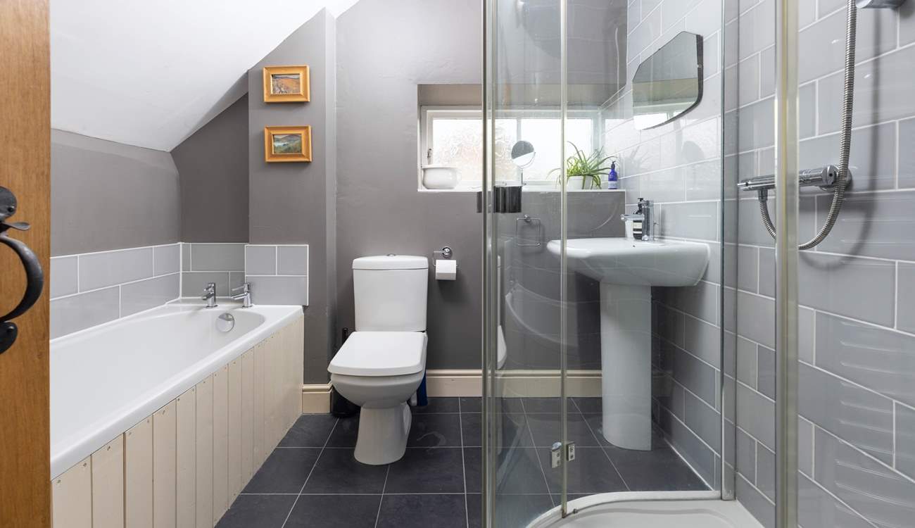 The family bathroom has a bath and luxurious shower unit.