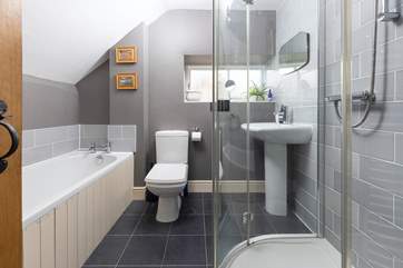 The family bathroom has a bath and luxurious shower unit.