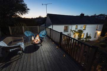 The upper deck has a fabulous fire-pit to toast marshmallows around. (Please note the sofa has been removed from the property).