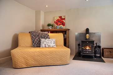When not in use the day bed is set up as a sofa, perfect to snuggle up next to yet another wood-burning stove (if children are staying in this room - matches, logs etc can be removed).