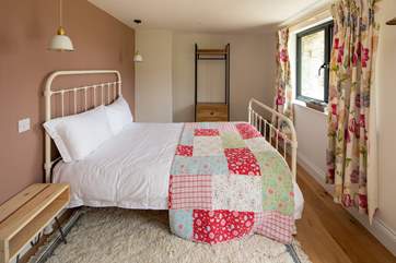 Bedroom two is colourful and charming.