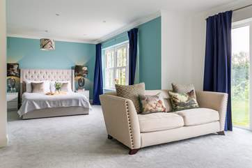 The sumptuous suite with luxury bed linens and garden views.