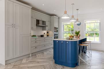 The stylish kitchen fills with natural light and is the perfect place for chatting to guests.
