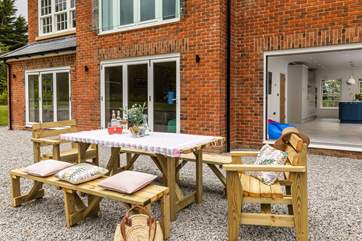 Bi-fold doors invite you to dine al fresco.