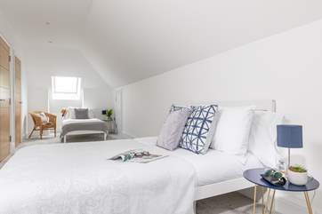 Light filled luxurious Bedroom 5 has a double and single bed on the top floor.