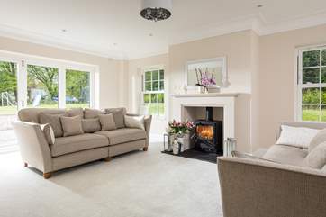 The beautiful sitting-room fills with natural light (the wood-burner is ornamental only).