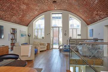 The stunning open plan living-room with the fantastic brick arched ceiling, this is a very sociable space for relaxing with family and friends.