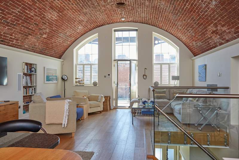 The stunning open plan living-room with the fantastic brick arched ceiling, this is a very sociable space for relaxing with family and friends.
