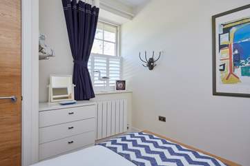 The bedrooms and first floor living room showcase plantation shutters.