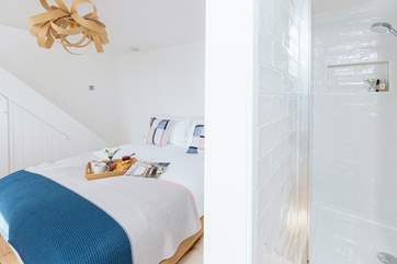 The bedroom on the ground floor has a compact en suite shower-room.