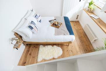 The lovely bedroom is on the ground floor and the living space is on the first floor.