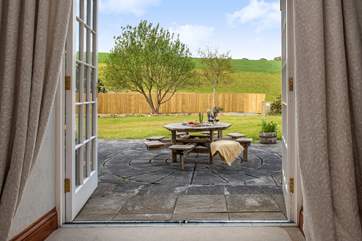 Patio doors lead out from the sitting-room to the garden.