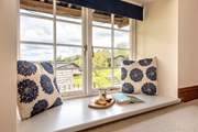 The windows frame the countryside views.
