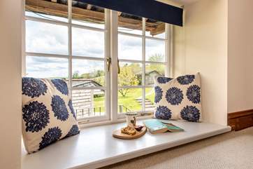 The windows frame the countryside views.