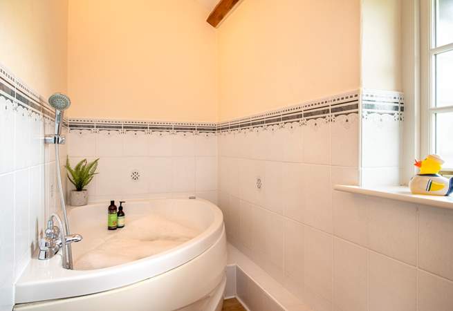 The family bathroom has the luxury of a spa bath - so lie back and relax.