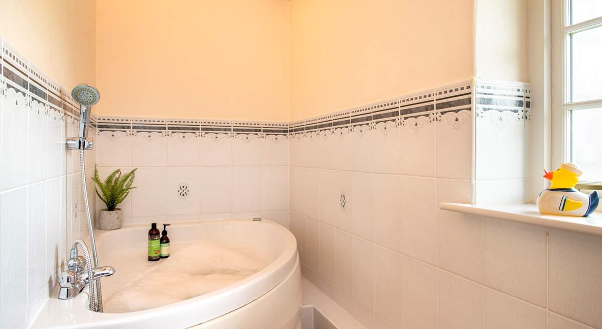 The family bathroom has the luxury of a spa bath - so lie back and relax.