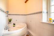 The family bathroom has the luxury of a spa bath - so lie back and relax.