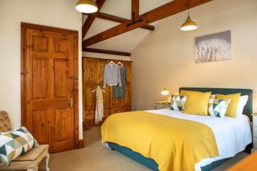 Lovely cushions and throws adorn the king-size bed in bedroom 4.