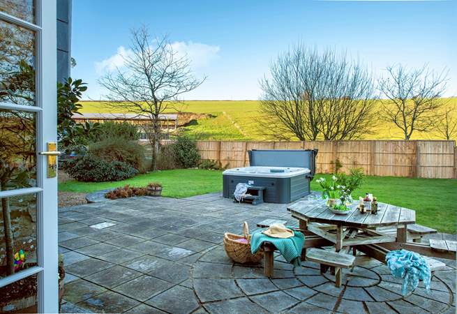 Patio doors lead out from the sitting-room to the garden.