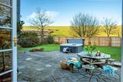 Patio doors lead out from the sitting-room to the garden.
