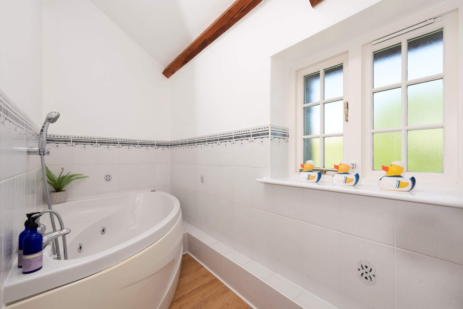 The family bathroom has the luxury of a spa bath - so lie back and relax.