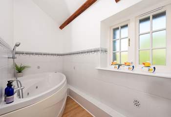 The family bathroom has the luxury of a spa bath - so lie back and relax.