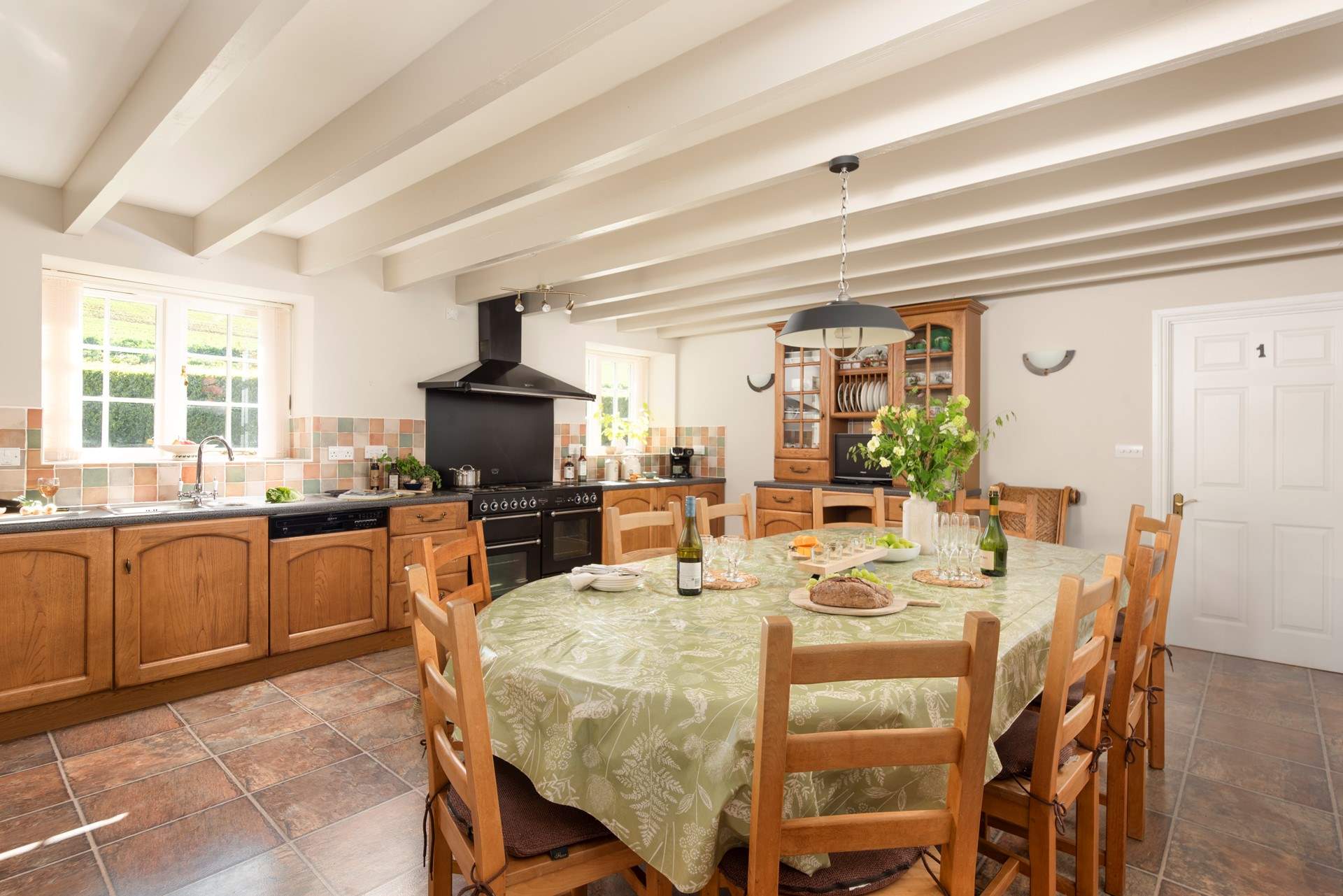 The spacious farmhouse-style kitchen/dining-room.