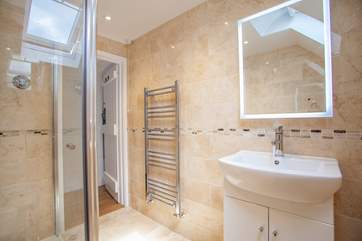 The shower-room fills with natural light from the Velux window.