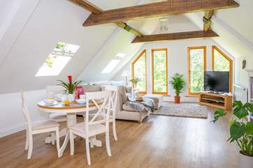 The open plan living area enjoys amazing views of the garden and surrounding woodland.